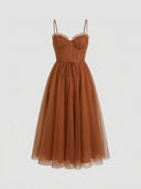 Brown spaghetti strap mini dress with ruffled bust and flared tulle skirt, front view.