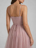 Dusty rose spaghetti strap flared mini dress with back zipper and waist tie, back view.