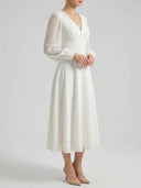 White V-neck A-line midi dress with sheer long sleeves, front view on a light background.