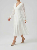 White V-neck midi dress with sheer long sleeves, ruched waist, and A-line skirt, angled view.
