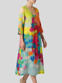 Colorful abstract print midi dress with V-neck and 3/4 sleeves, angled front view on a light background.