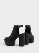 Black slingback platform heels with chunky block heel, serrated lug sole, and silver buckle ankle strap, angled view on white background.