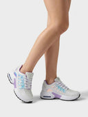 Angled front view of chunky white trainers showing iridescent teal-to-pink holographic overlay on toe box and midfoot with purple collar trim.
