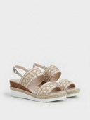 Pair of beige espadrille wedge sandals with embroidered geometric zigzag wide strap and rope-jute platform trim, angled view on white background.