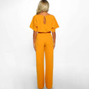 Orange short-sleeve jumpsuit with round neck and keyhole back, rear view on white background.