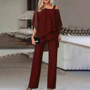 Maroon cold-shoulder chiffon jumpsuit with flowy long legs, front view on a blurred background.