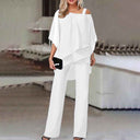 White cold-shoulder chiffon jumpsuit with flowy long legs, front view on a blurred background.