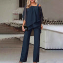 Navy cold-shoulder chiffon jumpsuit with flowy long legs, front view on a blurred background.