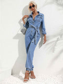 Light blue denim jumpsuit with flap pockets, front buttons, and tie waist, angled view.