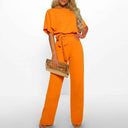 Orange jumpsuit with wide legs, short sleeves, and a tied waist, front view.