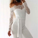 White lace off-shoulder jumpsuit with long sleeves and waist tie, angled front view.