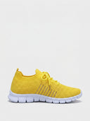 Yellow mesh lace-up trainer with white segmented cushioned sole, side view on white background.