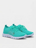 Teal mesh trainers with white segmented sole and silver reflective stripe detail, angled side view.