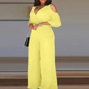 Yellow jumpsuit with cold shoulder sleeves, V-neck, and wide legs, front view.