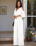 White cold-shoulder jumpsuit with V-neck and tie waist, front view.