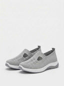 Grey slip-on knit comfort trainers with chunky two-tone sole — side profile view showing low-cut court silhouette.