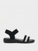White elastic flat sandals with white striped toe strap and ankle band, side view on white background.