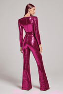 Magenta sequin jumpsuit with long sleeves and flared legs, shown from the back on a light background.