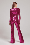 Magenta sequin jumpsuit with long sleeves and flared legs, back view on a gray background.