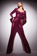 Magenta sequin jumpsuit with long sleeves and flared legs, front view on a white background.