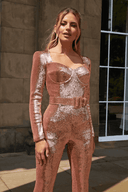 Rose gold sequin jumpsuit with long sleeves, square neckline, and belted waist, front view.