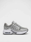 Air cushion chunky trainers in grey - front view showing mesh upper, drip-slot cage panel, and white EVA midsole with visible heel air unit.