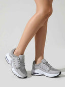 Grey air cushion lace-up trainers - angled three-quarter view highlighting the moulded lateral cage detail and chunky dad-trainer silhouette.
