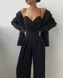 Black strappy jumpsuit with sweetheart neckline, wide legs, and matching blazer, front view.