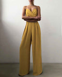 Mustard yellow strappy jumpsuit with wide legs and pleated bodice, front view on white background.