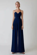Navy blue spaghetti strap overall with flared hemline, front view on white background.