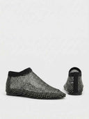 Black rhinestone mesh flat slip-on shoes, front and back angled view showing knit ankle band and rhinestone-covered upper.