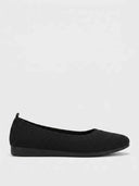 Black ribbed knit ballet flat with rounded toe and flat sole, side profile on white background.