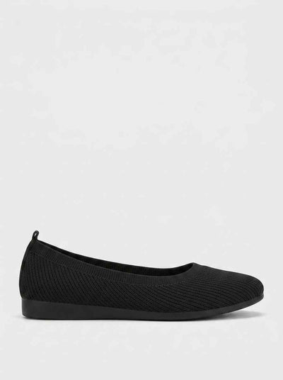 Black ribbed knit ballet flat with rounded toe and flat sole, side profile on white background.