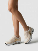 Air cushion lace-up trainers in beige colour-block — angled view showing mesh panels, suede-look overlays, and metallic gold synthetic detail.