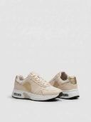 Air cushion lace-up trainers close-up detail showing metallic gold synthetic panel, mesh fabric, and padded collar construction.