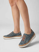 Slip-on perforated trainers showing diamond laser-cut upper and multicolour elastic gusset, angled three-quarter view.