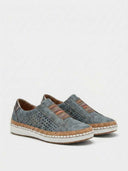 Slip-on cushioned trainers with cork-effect midsole and metallic pewter heel tab, side profile view.
