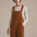 Brown corduroy boiler suit with wide legs over a light ribbed top, front view.