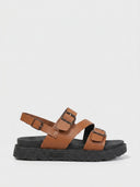 Brown chunky platform sandals with three buckle straps and slingback, lug-tread rubber sole, angled side view on white background.