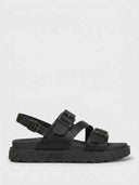 Black chunky platform sandals with three wide buckle straps and a slingback ankle strap, lug-tread rubber sole, side view on white background.
