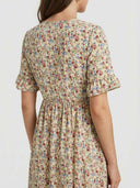 Cream floral midi dress with ruffled sleeves and elastic waist, back view.