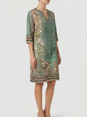 Green floral midi dress with V-neck and 3/4 sleeves, side view on white background.