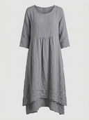 Gray linen mini dress with 3/4 sleeves, round neck, and tiered skirt, front view on a white background.