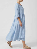 Light blue linen midi dress with ruffled neckline and sleeves, side view.