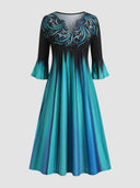 Black and blue gradient midi dress with V-neck, bell sleeves, and teal scroll pattern, front view.