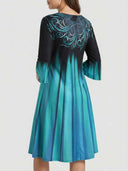 Black and blue gradient midi dress with ornate back design, back view.