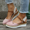 Pink closed-toe espadrille wedge sandals with cream canvas panel, tan ankle strap, and jute-wrapped platform sole, angled side view.
