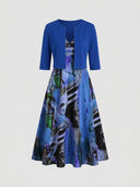 Blue bolero over a V-neck maxi dress with abstract blue, green, and black print, front view.