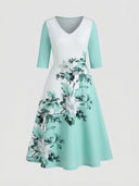 White and mint green V-neck maxi dress with floral print, front view on a white background.