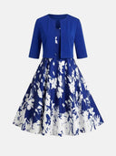Blue dress with white floral print and matching blue bolero jacket, front view.
